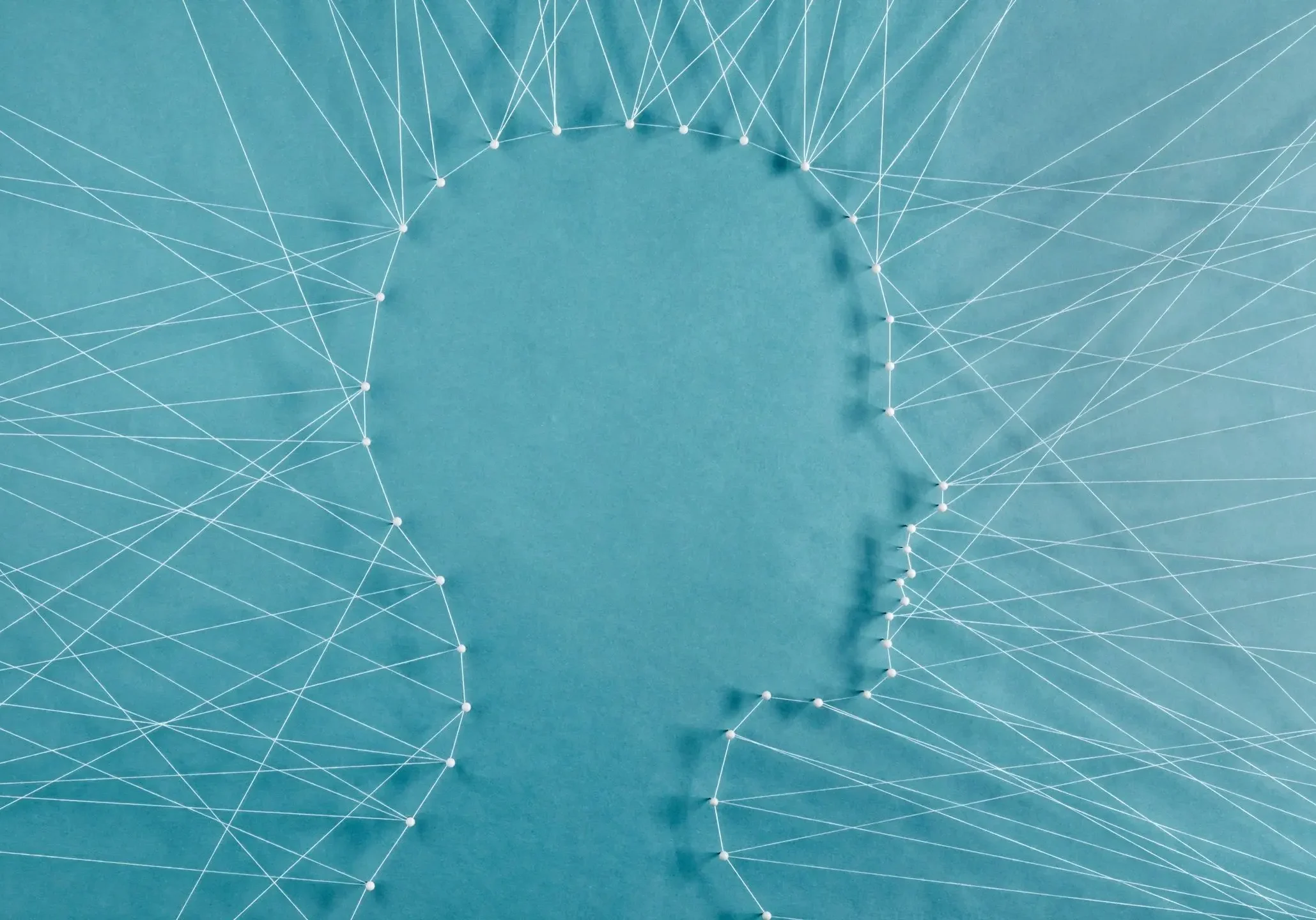 Silhouette with interconnected lines on blue background.